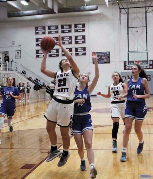 Celeste Reed goes up strong to the basket as Nia Powers trails during action against Christian Academy at Knoxville, at the Nov.19 game, at Sparta